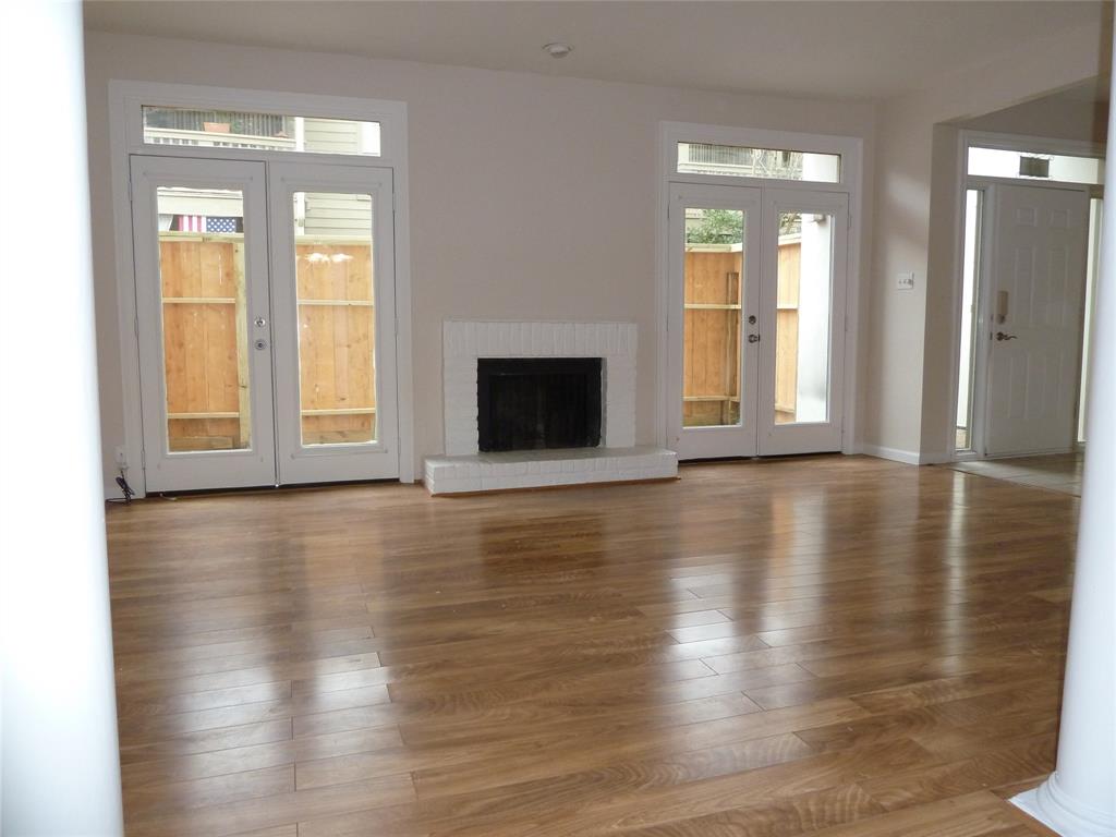a view of a livingroom with wooden floor and a window