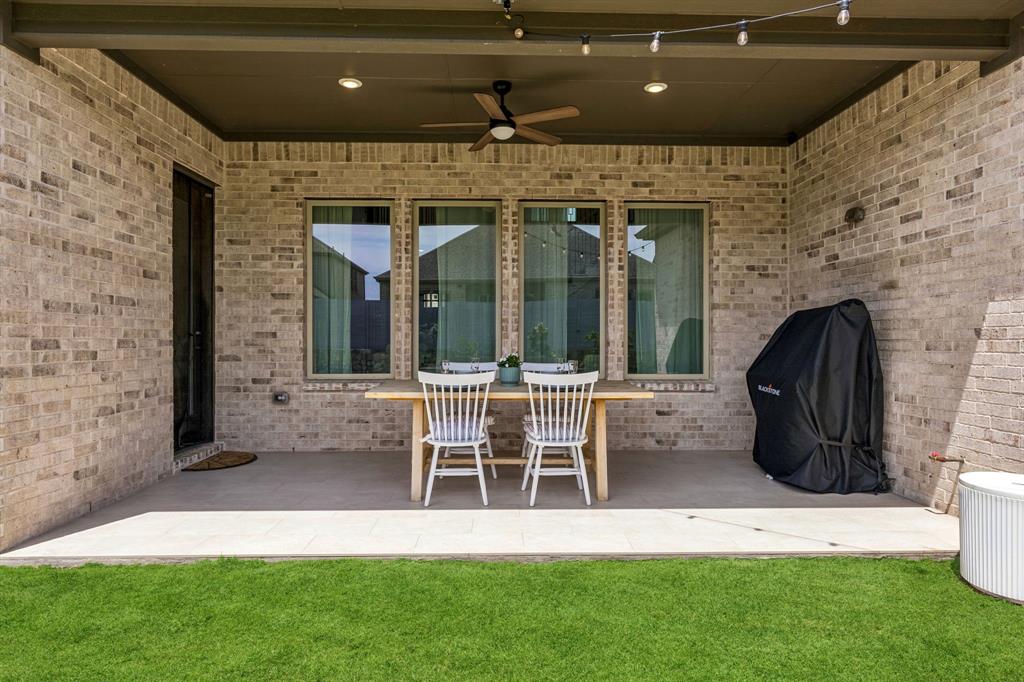 3004 Windy Rdg Road McKinney, TX 75071 - Photo 31 of 40 a front view of a house with a garden and patio
