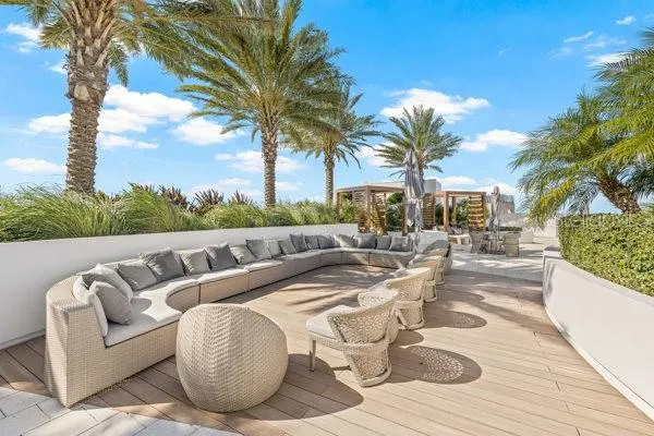 a view of swimming pool with outdoor seating and plants