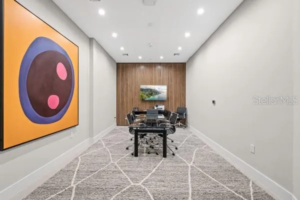 a view of a room with a table and chairs