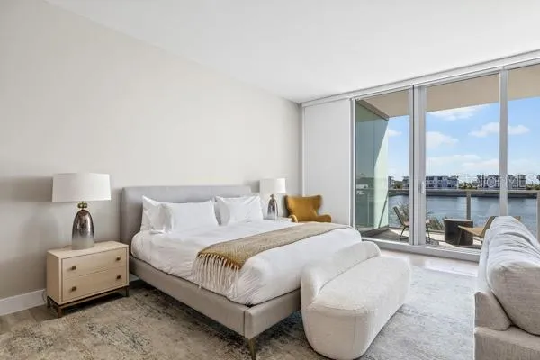 a bedroom with a bed and large window