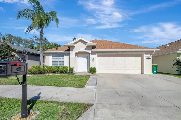 a front view of a house with a yard and garage