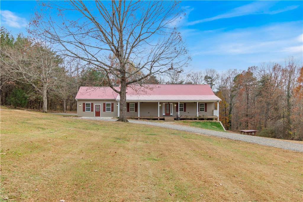 6475 Ransom Free Road Clermont, GA 30527 - Photo 1 of 1 a front view of a house with garden