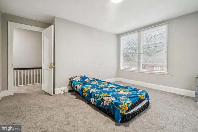 a bedroom with bed and a window