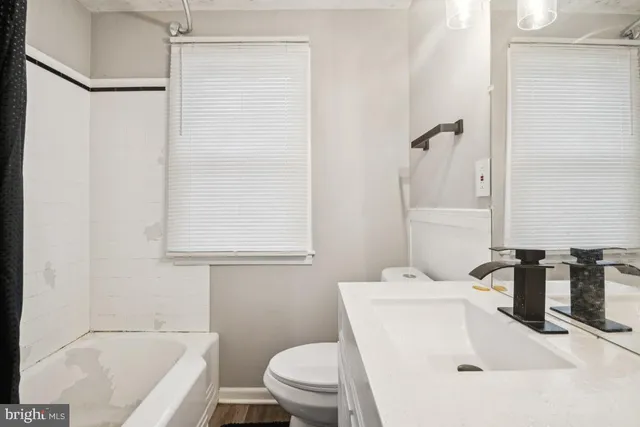a bathroom with a sink a toilet and bathtub