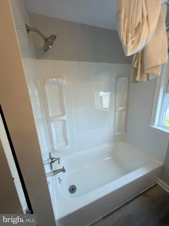 a bath tub sitting next to a bathroom sink