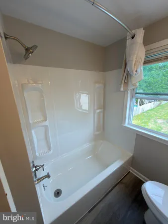 a bathroom with a tub and a window