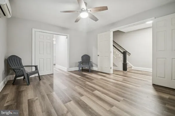 a view of a workspace with furniture and wooden floor