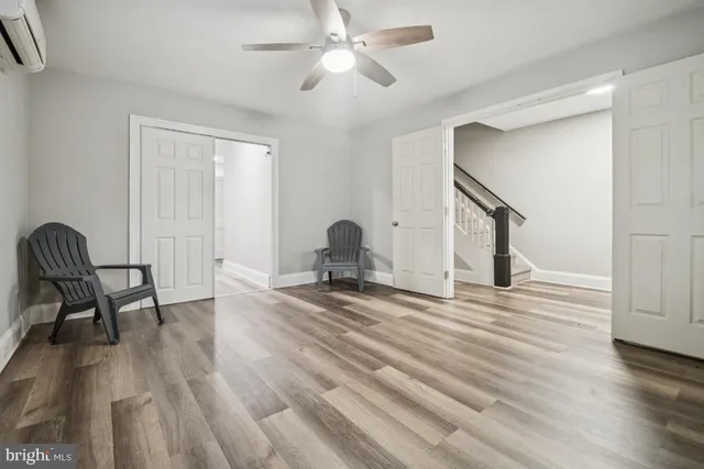 a view of a workspace with furniture and wooden floor