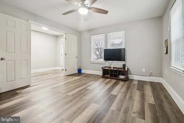 a view of room with wooden floor and flat screen tv