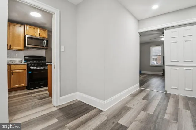 a view of a kitchen with wooden floor and a sink
