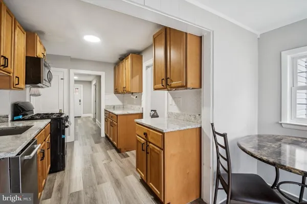 a kitchen with stainless steel appliances granite countertop sink stove top oven and cabinets