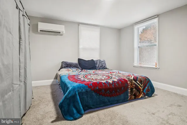 a bedroom with a bed and window