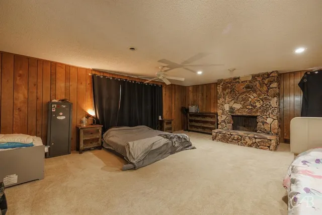 a spacious bedroom with a bed and a fireplace