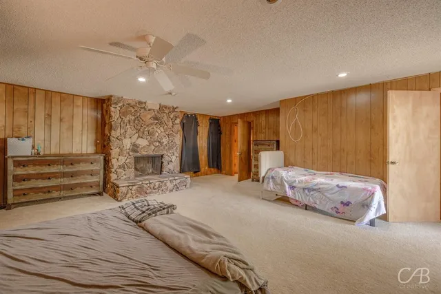 a spacious bedroom with a large bed a chandelier and closet