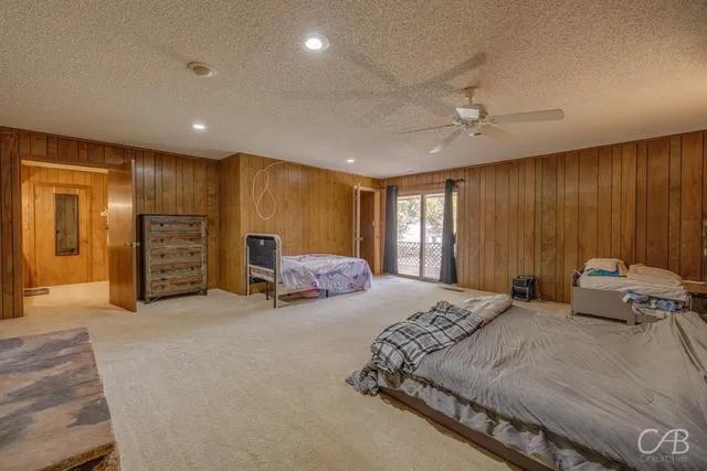 a spacious bedroom with a bed and a couch