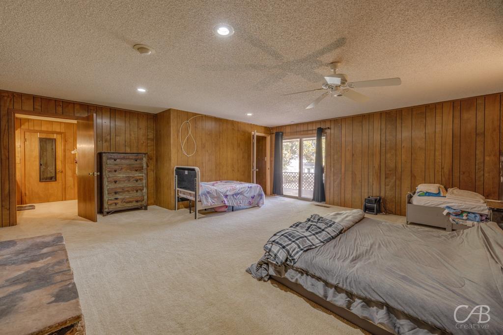 33 Northwest Ave A Hamlin, TX 79520 - Photo 13 of 37 a spacious bedroom with a bed and a couch