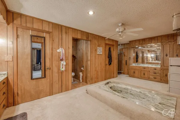 a bedroom with a bed and a large mirror