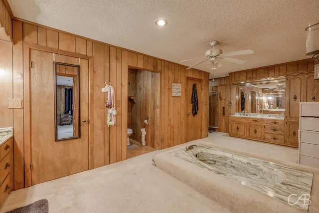 a bedroom with a bed and a large mirror