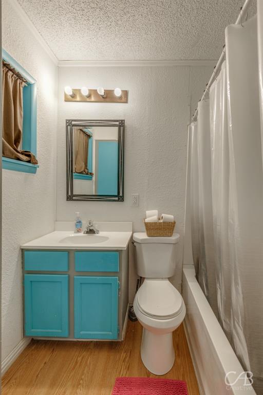 33 Northwest Ave A Hamlin, TX 79520 - Photo 24 of 37 a bathroom with a toilet sink and mirror