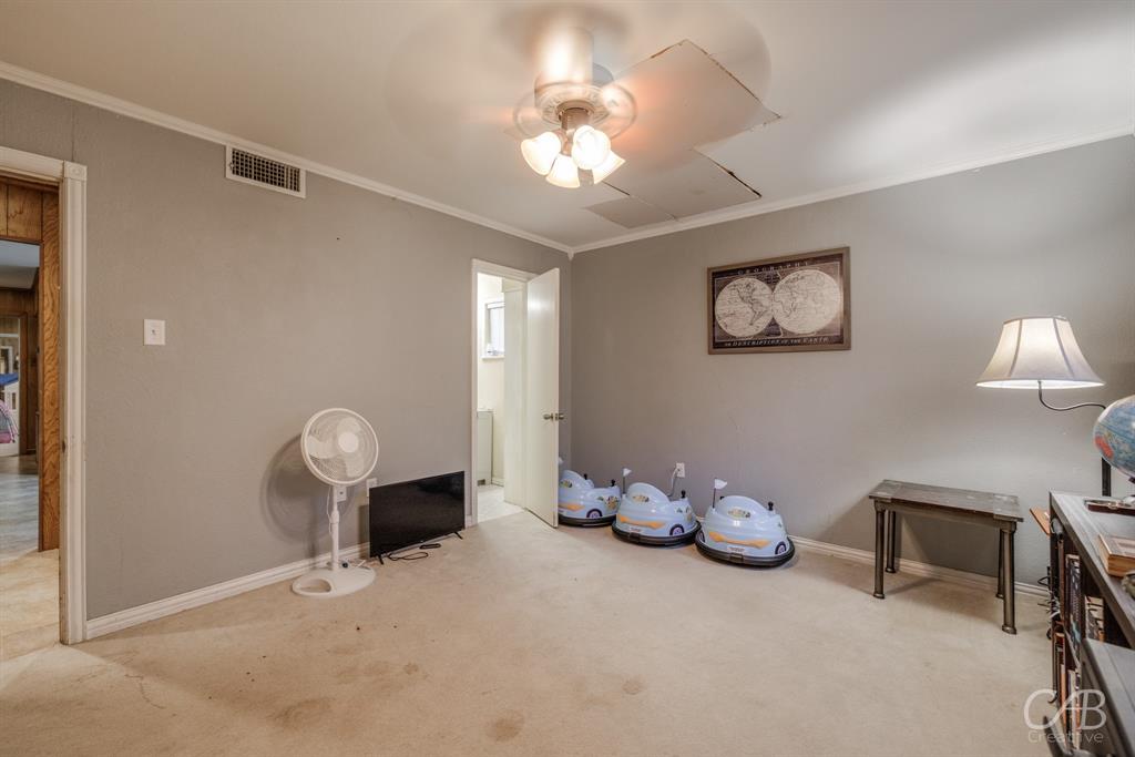 33 Northwest Ave A Hamlin, TX 79520 - Photo 26 of 37 a room with toys and a chandelier fan