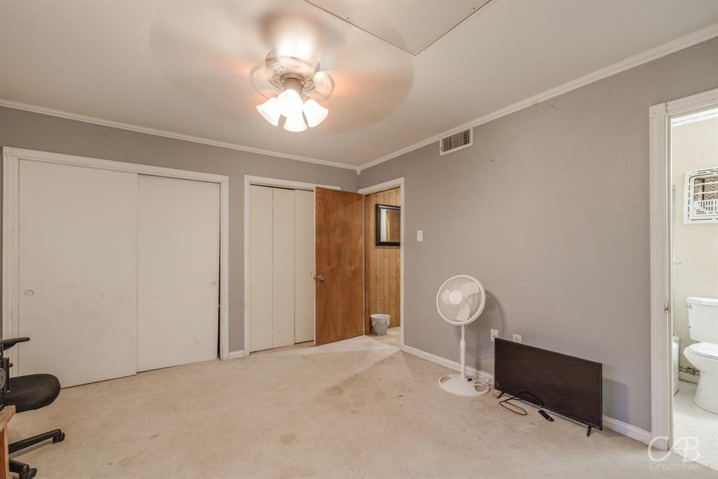 33 Northwest Ave A Hamlin, TX 79520 - Photo 27 of 37 a view of an empty room with wooden floor and fan