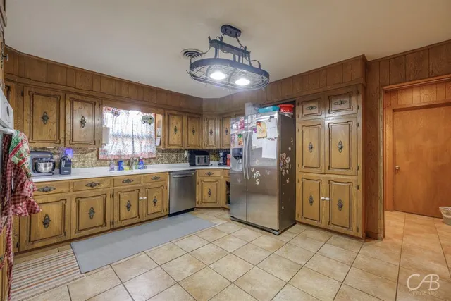 a kitchen with refrigerator and cabinets