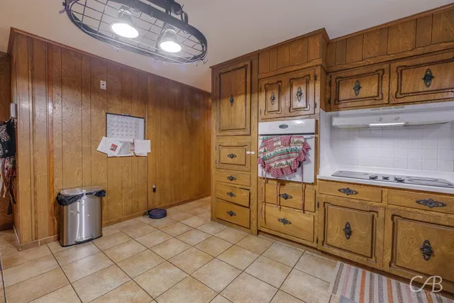 a view of a refrigerator and cabinet