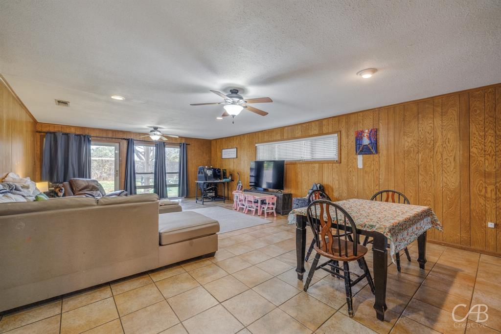 33 Northwest Ave A Hamlin, TX 79520 - Photo 6 of 37 a living room with furniture a chandelier and a dining table