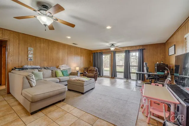 a living room with furniture ceiling fan and a rug