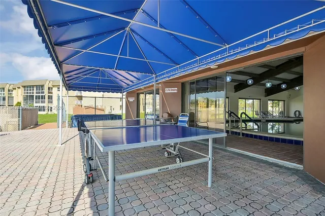 a view of a dinning table and chairs in the patio