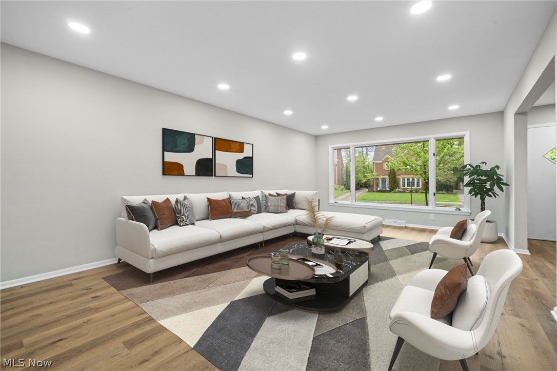 2375 Glendon Road University Heights, OH 44118 - Photo 6 of 50 Living area featuring light gray walls, recessed ceiling lighting, a prominent bay window, wood-finish flooring, and white baseboards