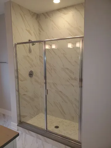 a bathroom with a glass shower door