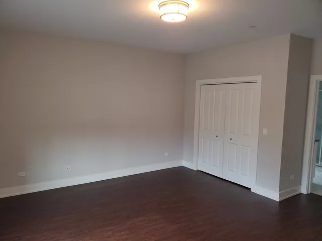 a view of an empty room and wooden floor
