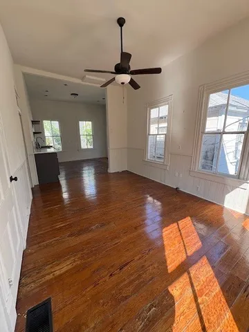 wooden floor in an empty room with a window