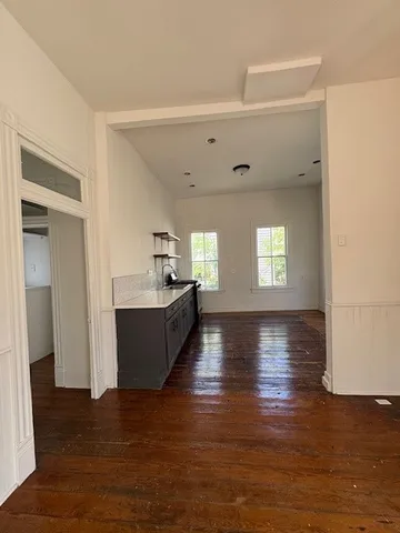 a view of kitchen and hall with wooden floor