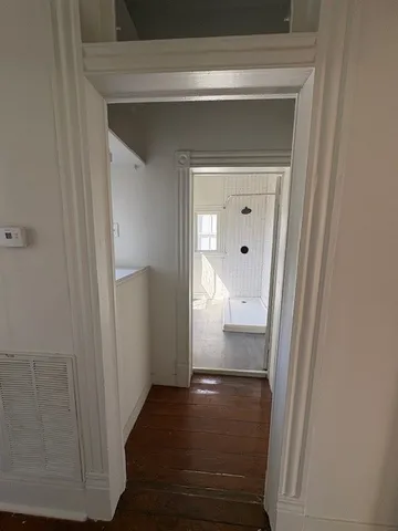 a view of hallway with wooden floor