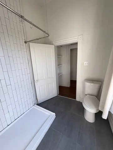 a view of a closet with wooden floor