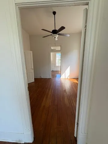 a view of a hallway with wooden floor