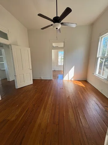 wooden floor in an empty room with a window
