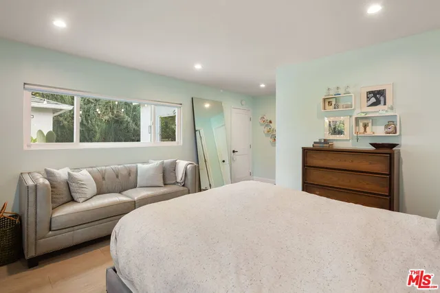 a bedroom with furniture and windows