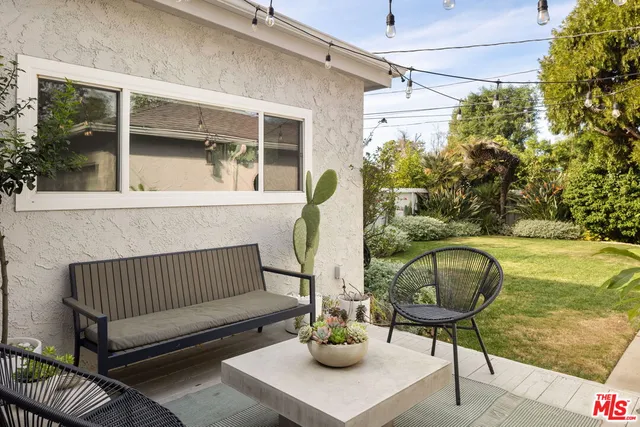 a view of a patio with couple of chairs and a table