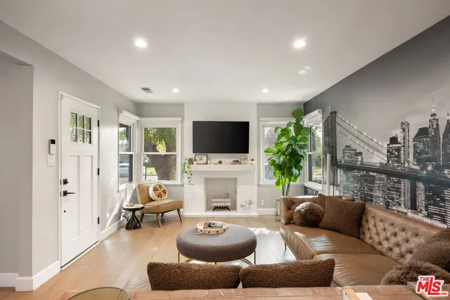 a living room with furniture a fireplace and a flat screen tv