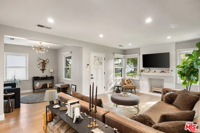a living room with furniture flat screen tv and a fireplace