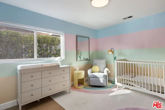 a spacious bedroom with a bed and a window