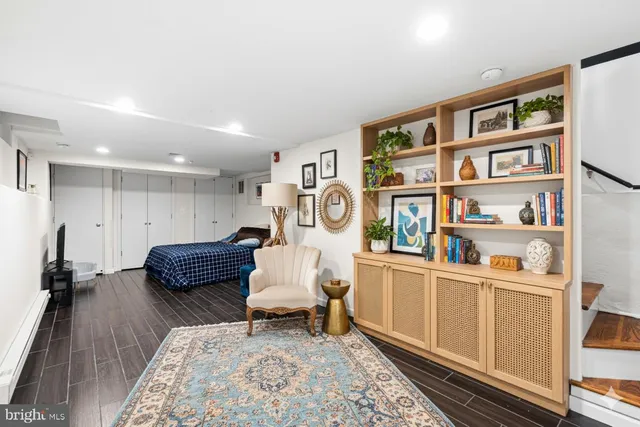 a living room with furniture and a book shelf