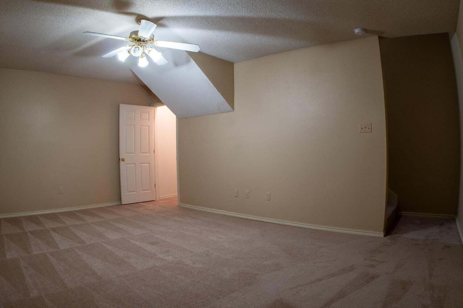 3413 97th Street Lubbock, TX 79423 - Photo 16 of 21 an empty room with a chandelier fan
