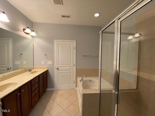 10103 Falls Meadow Court Raleigh, NC 27617 - Photo 15 of 54 a bathroom with a double vanity sink a mirror and a shower