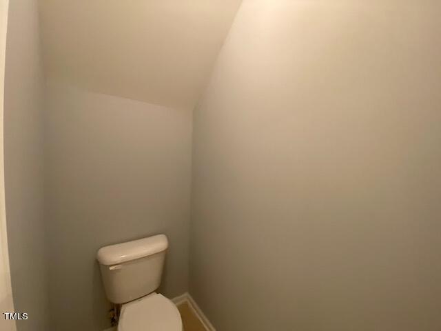 10103 Falls Meadow Court Raleigh, NC 27617 - Photo 17 of 54 a white toilet sitting next to a white wall