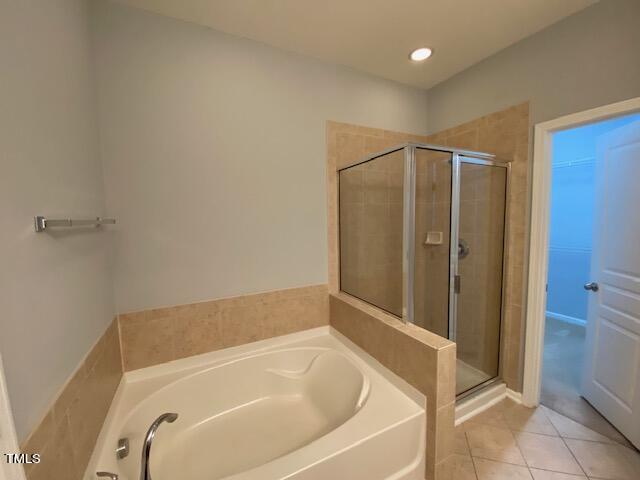 10103 Falls Meadow Court Raleigh, NC 27617 - Photo 18 of 54 a bathroom with a tub and shower